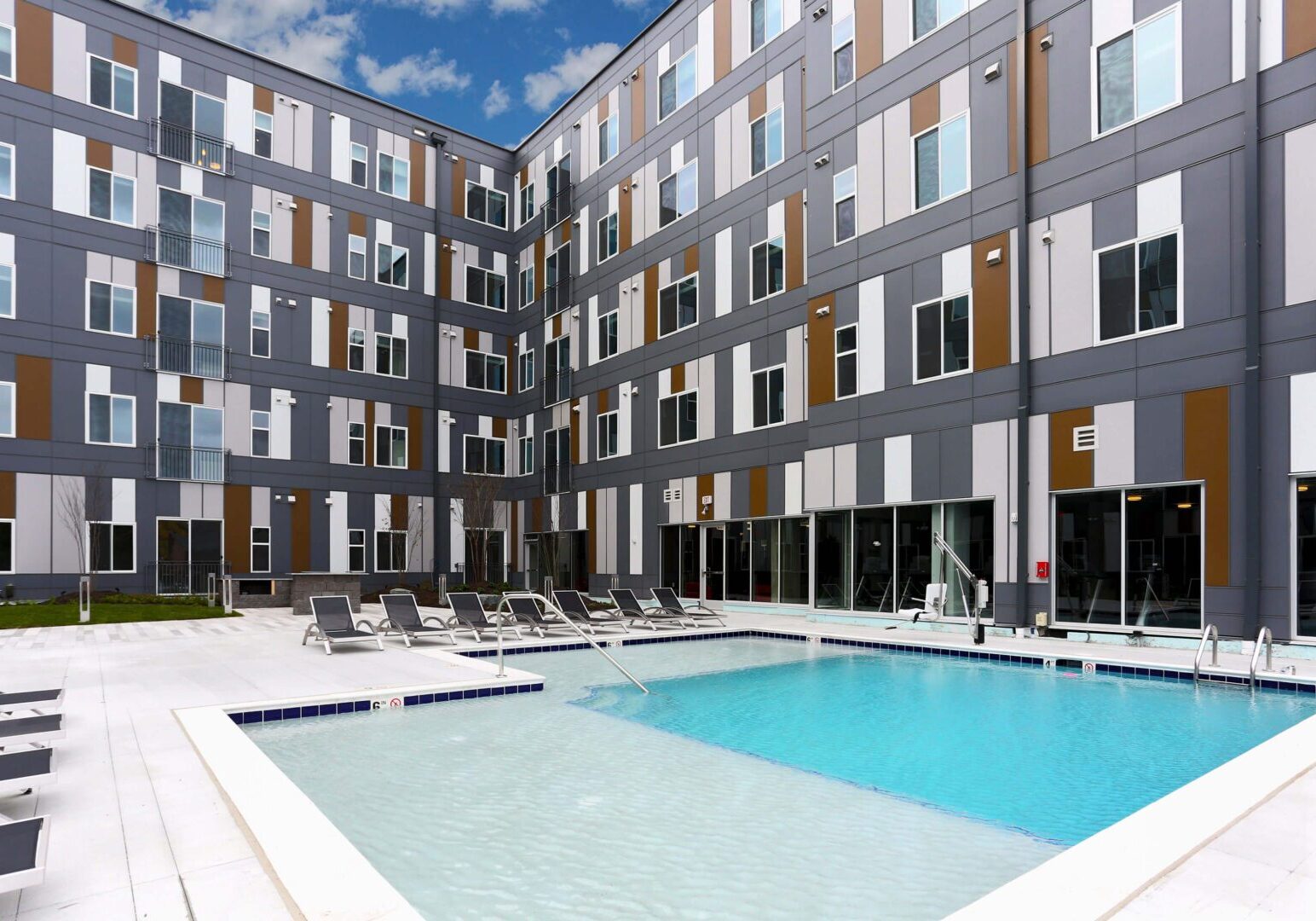 Swimming pool in front of apartment building.